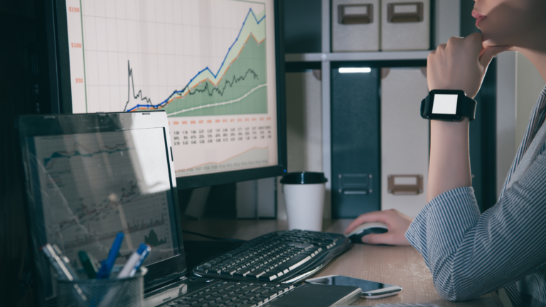 A young man looking at stock information on a computer