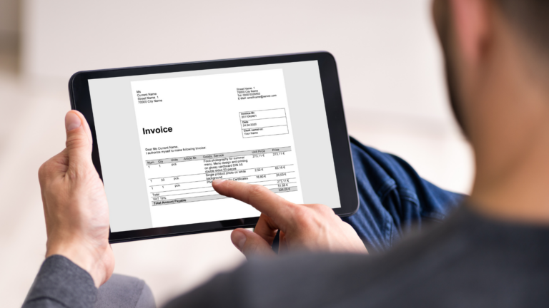 An image of a small business owner reviewing the GST/HST on his invoices