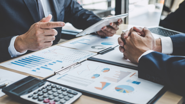 An image of two small business owners reviewing their bookkeeping records.