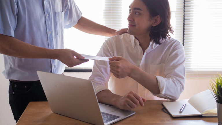 An image of a small business owner being paid by check his salary or dividend amount