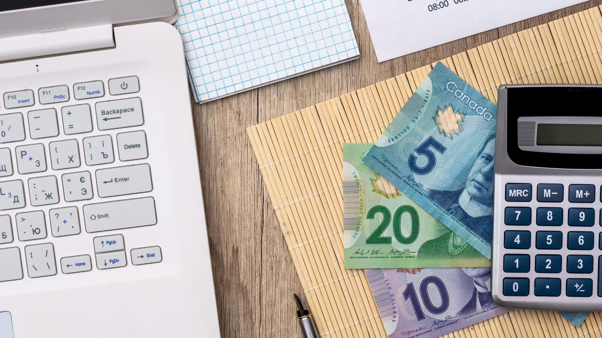 An image of a desktop with some Canadian money below a calculator