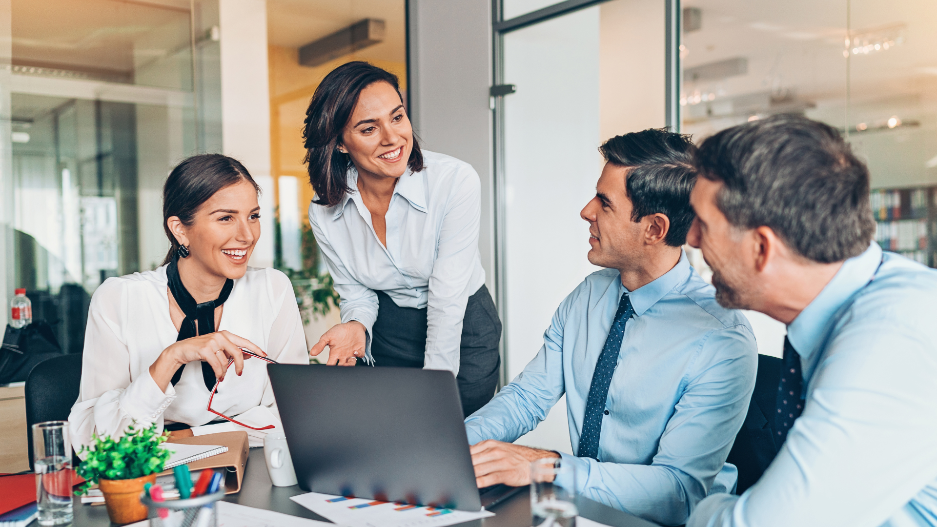 An image of a small business owner meeting with their team in a small boardroom in Markham Ontario