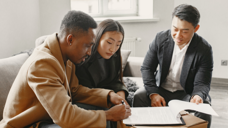 An image of a local Markham financial consultant meeting with his clients to discuss their financial plans for the coming year.