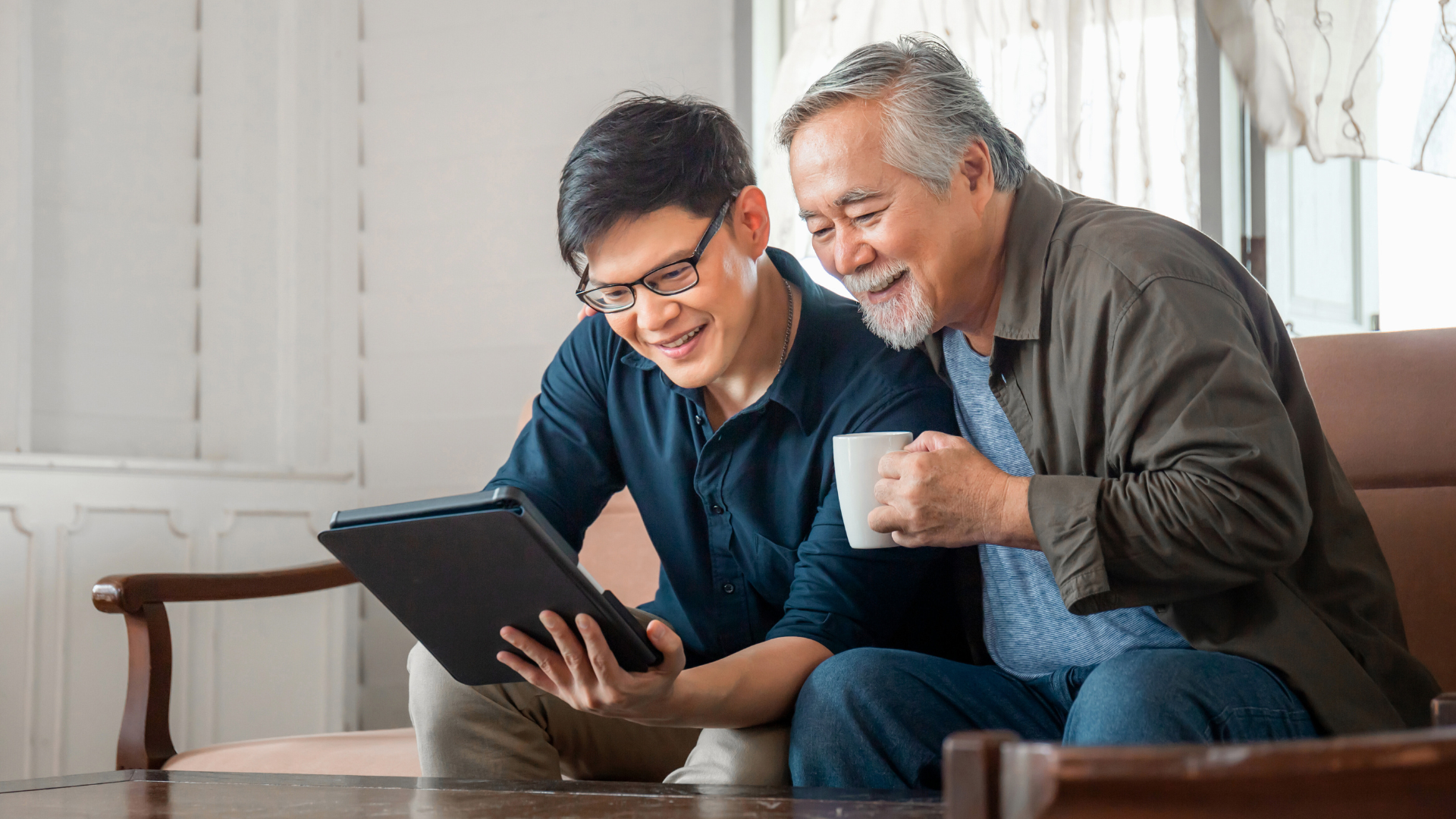 An image of a father and son who just spoke with their tax advisor at KSSP Partners LLP in Markham about his OAS and how it will impact his estate plan.