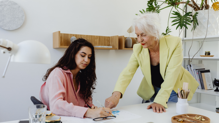An image of an elderly business leader engaged in mentorship at their Markham office.