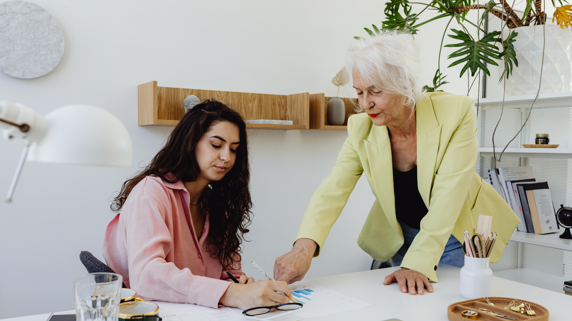 An image of an elderly business leader engaged in mentorship at their Markham office.